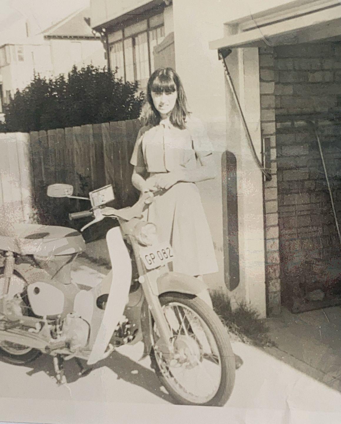 Riding motor scooter to school late 60s